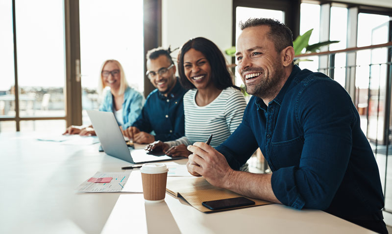 A group of people sitting at conference table