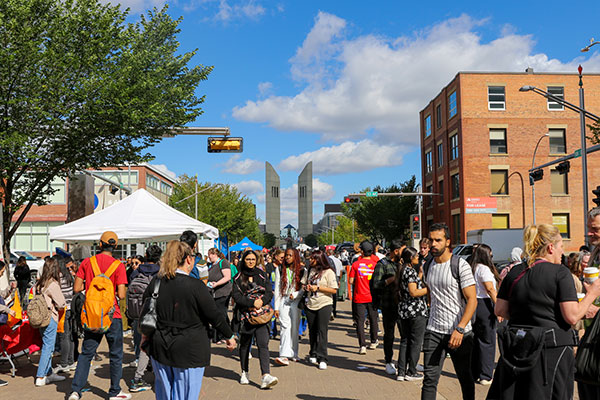 A crowd of people with booths lining the street